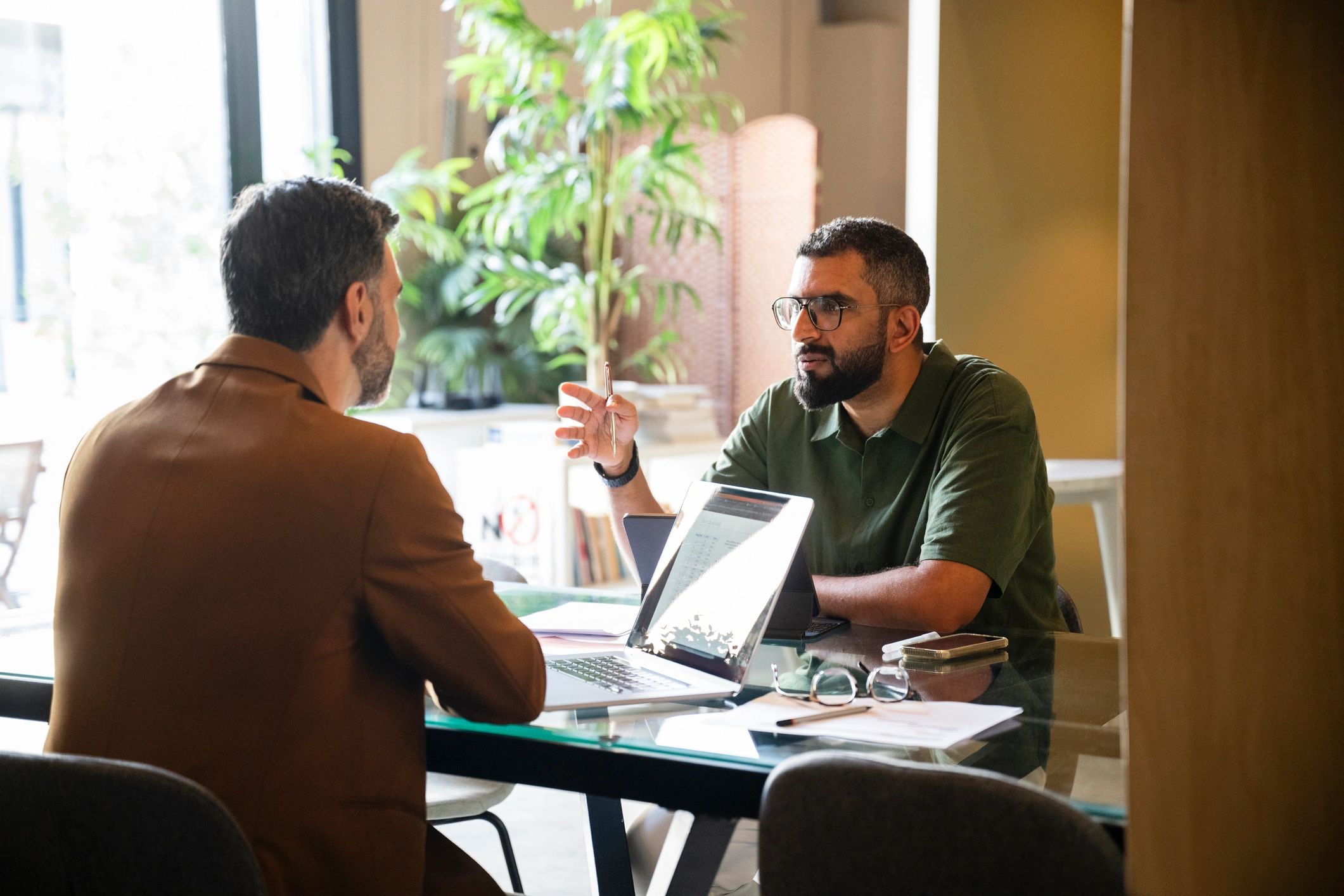 Insurance agent meeting with a client in a modern office