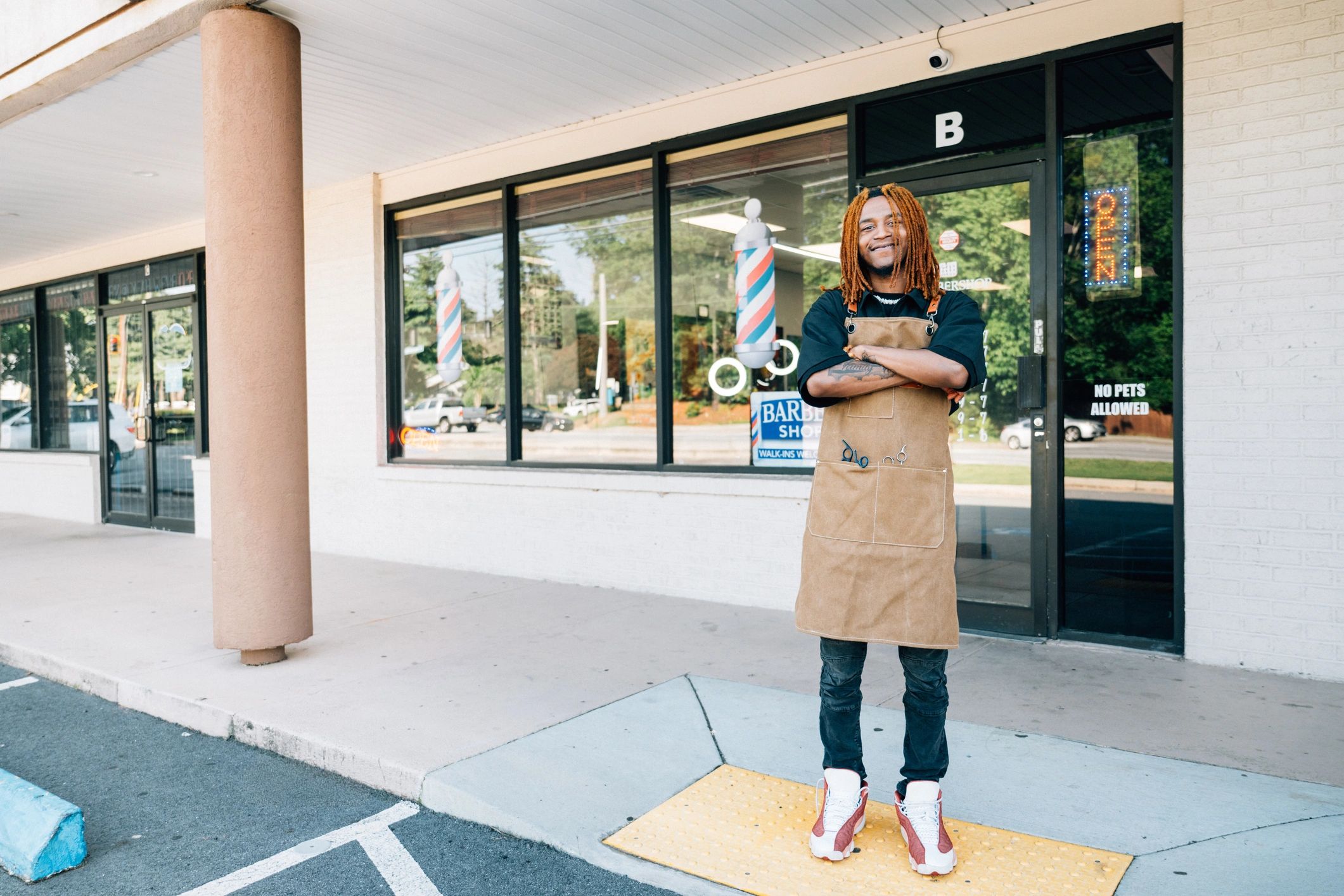 Small business owner standing in front of a storefront